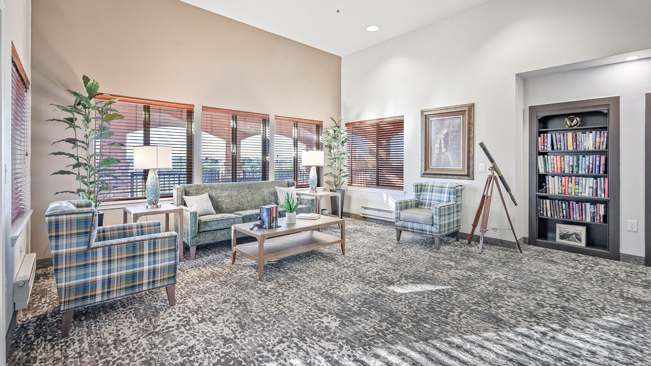 The library at Desert Springs with shelves of books and comfortable seating