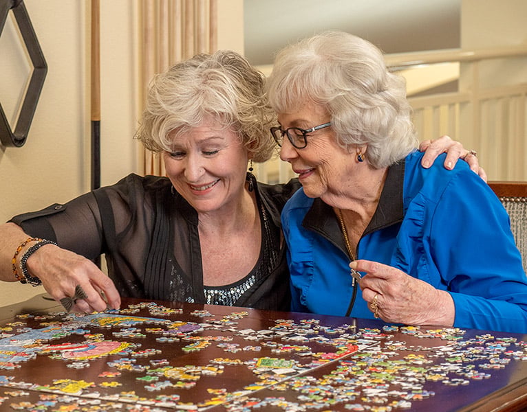 Residents working on a puzzle together at Desert Springs